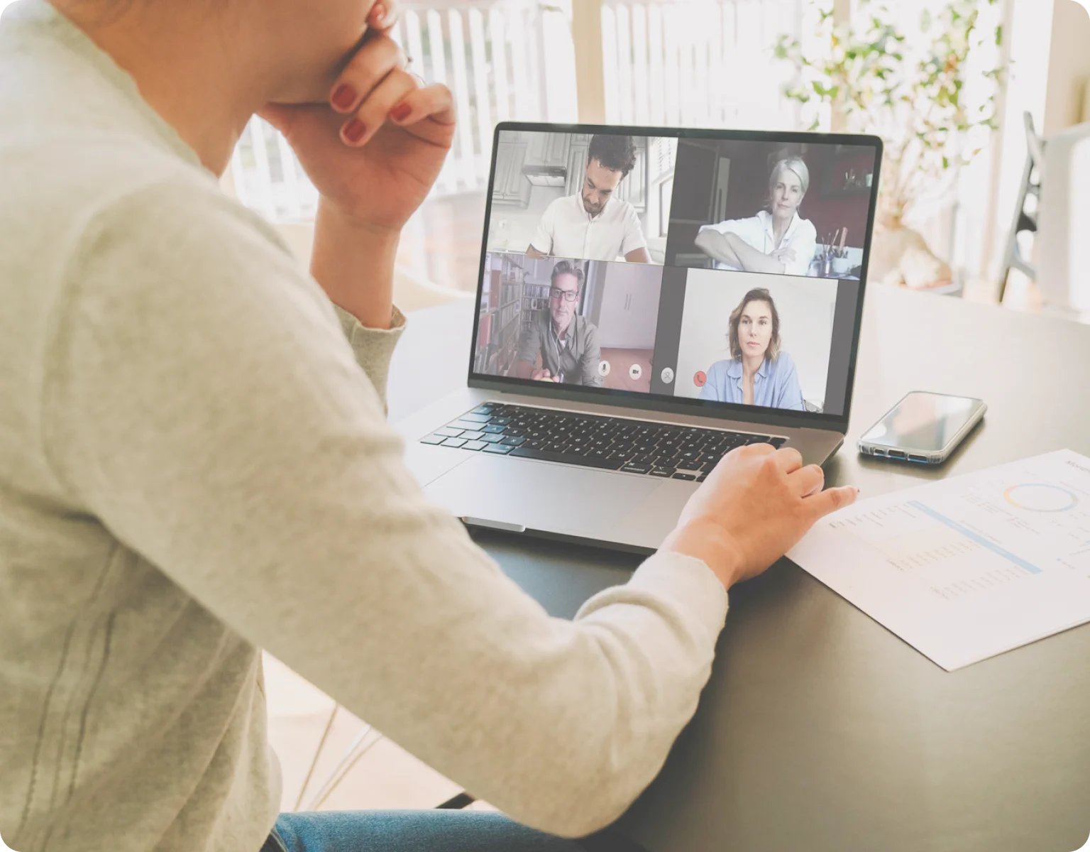 Person in a video call using a laptop